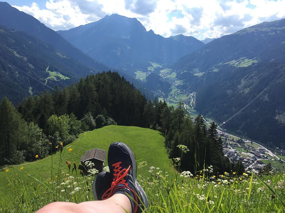 Image of alpine valley with walkers boots in foreground